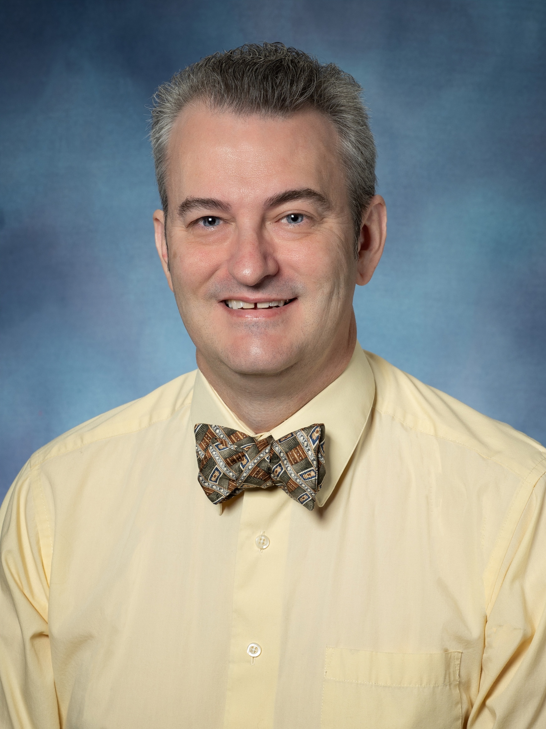 Doug Berry, MBA — smiling headshot wearing a patterned bow tie.
