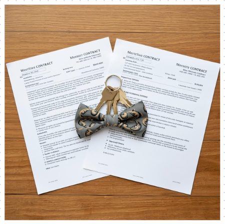 Seller reviewing multiple home purchase offers at a desk, comparing contract terms, financing types, and timelines before choosing the strongest offer.